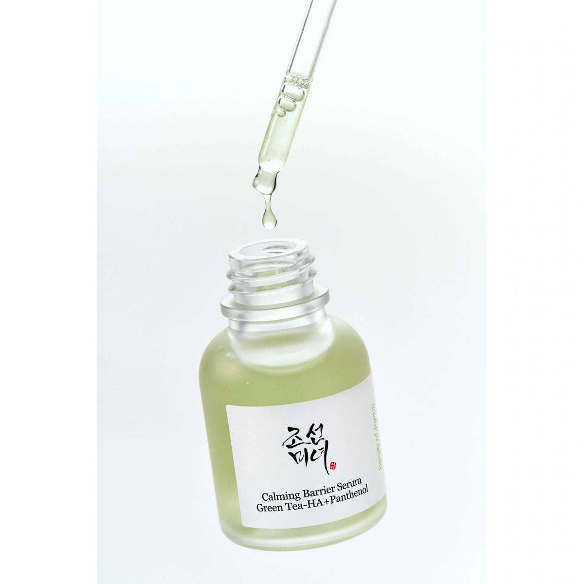 Beauty of Joseon Calming Barrier Serum 30ml open bottle with glass dropper releasing a green tea serum drop