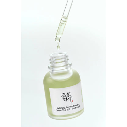Beauty of Joseon Calming Barrier Serum 30ml open bottle with glass dropper releasing a green tea serum drop