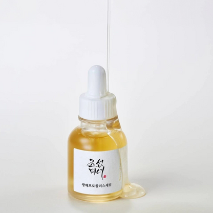 Beauty of Joseon Glow Serum Propolis + Niacinamide 30ml bottle with golden serum dripping from the dropper