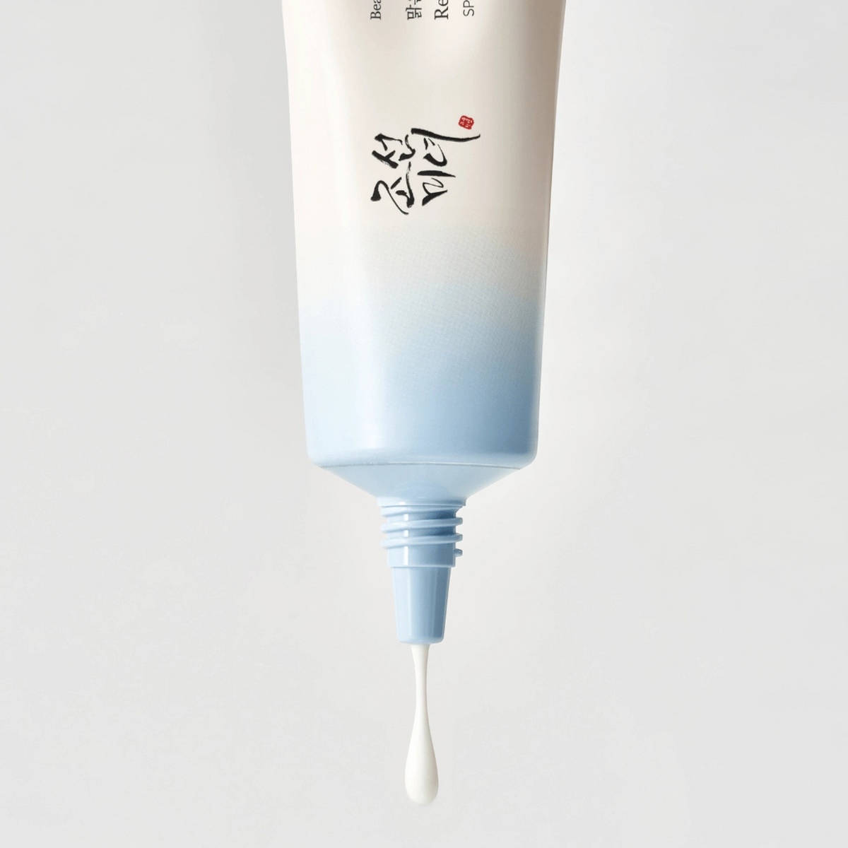 Beauty of Joseon Relief Sun Aqua-Fresh Rice + B5 50ml, close-up of white cream dripping from the tube nozzle